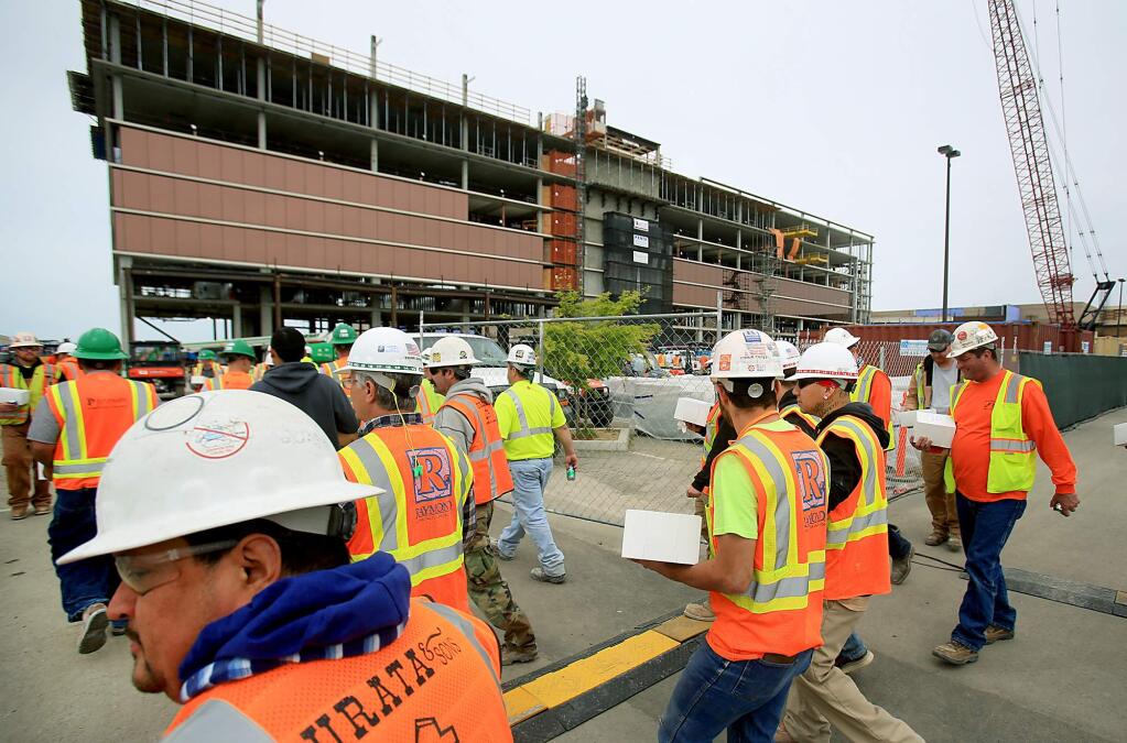 Construction workers carry their box lunches as they return to work on the hotel portion of the Graton Resort and Casino, Tuesday April 26, 2016 near Rohnert Park. (Kent Porter / Press Democrat) 2016