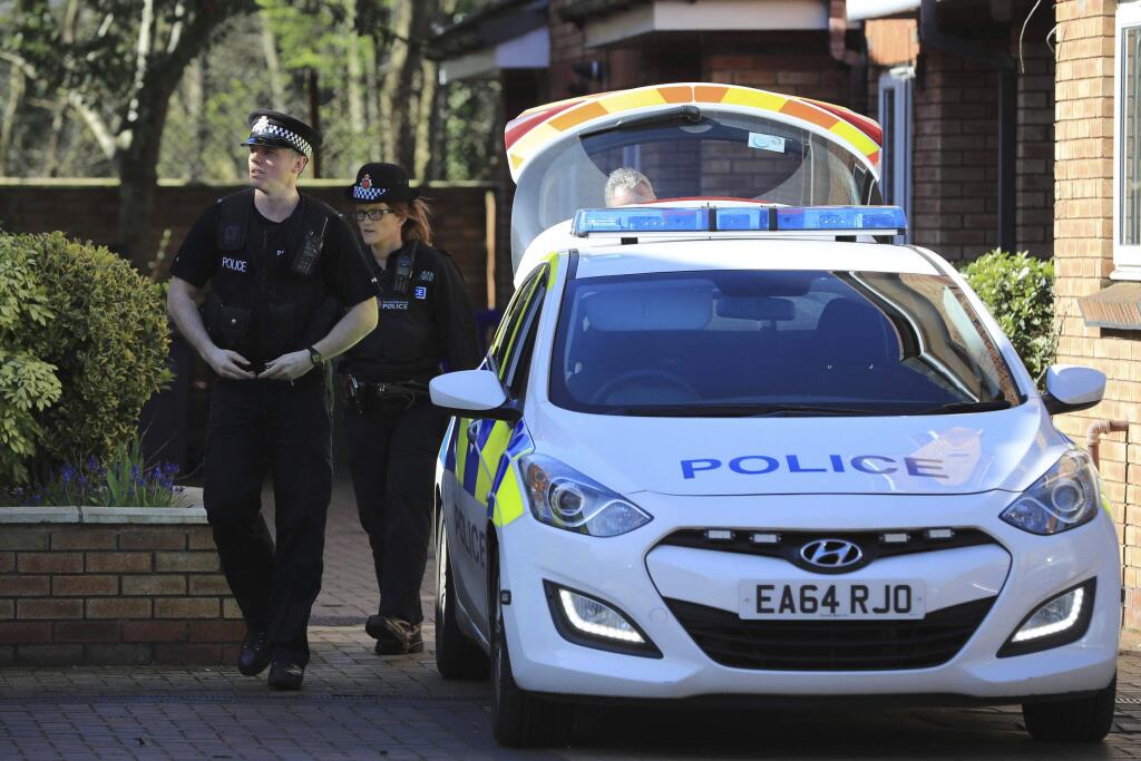 Police walk outside a property in Didsbury, England, Friday March 24, 2017. In a briefing outside Scotland Yard, London's top counterterror officer, Mark Rowley, said two more 'significant' arrests had been made, bringing to nine the number of people in custody over Wednesday's attack. (Peter Byrne, PA via AP)