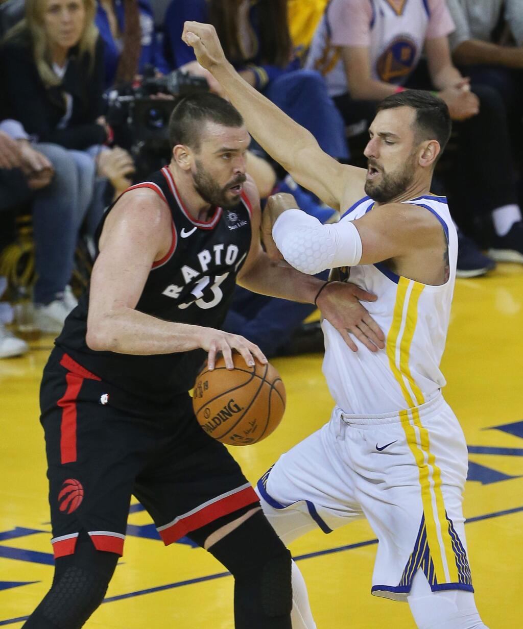 Golden State Warriors center Andrew Bogue defends against Toronto Raptors center Marc Gasol during game 3 of the NBA Finals in Oakland on Wednesday, June 5, 2019. (Christopher Chung/ The Press Democrat)