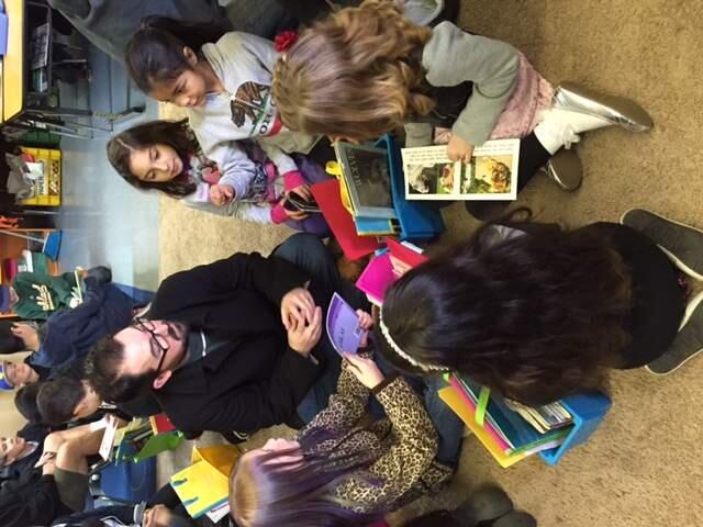 Children and parents are gathering to read and eat breakfast at El Verano.