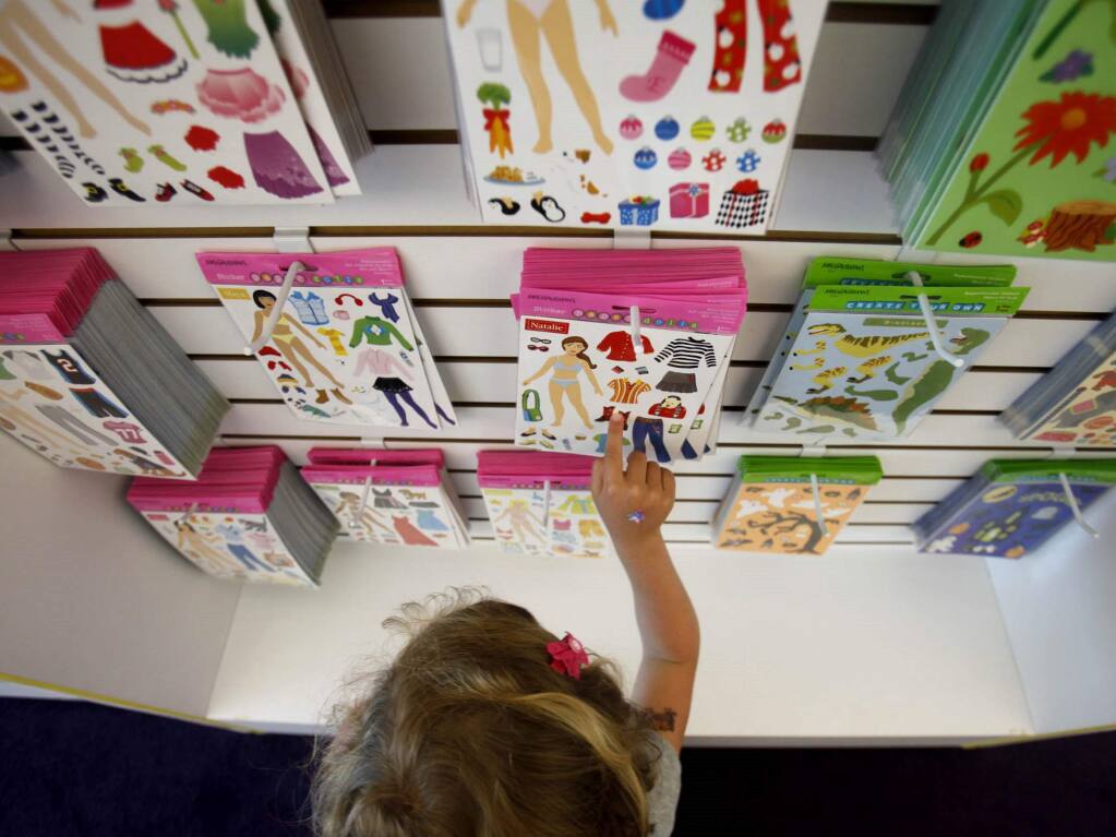 Sarah Hughes, 4, looks over a variety of stickers for sale in the retail shop at Mrs. Grossman's sticker factory on Wednesday, April 27, 2011, in Petaluma. (Beth Schlanker/ The Press Democrat)