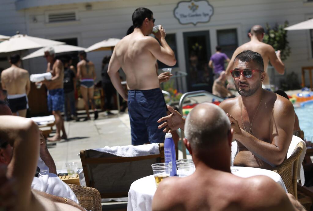 Men socialize during a pool party as part of Gay Wine Weekend at MacArthur Place on Sunday, June 21, 2015 in Sonoma. (BETH SCHLANKER/ The Press Democrat)