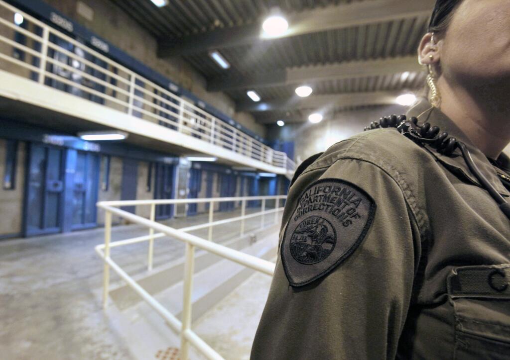 FILE - In this Aug. 17, 2011, file photo, a correctional officer works at one of the housing units at Pelican Bay State Prison near Crescent City, Calif. Federal prosecutors say leaders of a notorious white supremacist gang have been charged with directing killings and drug smuggling from within California's most secure prisons. The charges unsealed Thursday, June 6, 2019, detail five slayings and accuse an attorney of helping smuggle drugs and cell phones. (AP Photo/Rich Pedroncelli, File)
