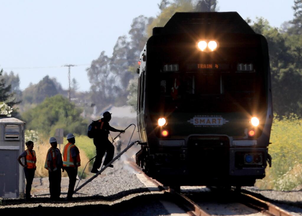 SMART personnel board a southbound train to check on passengers, Monday, July 15, 2019, after the commuter train struck a person on the tracks just before the Rohnert Park City limits. (Kent Porter / The Press Democrat) 2019
