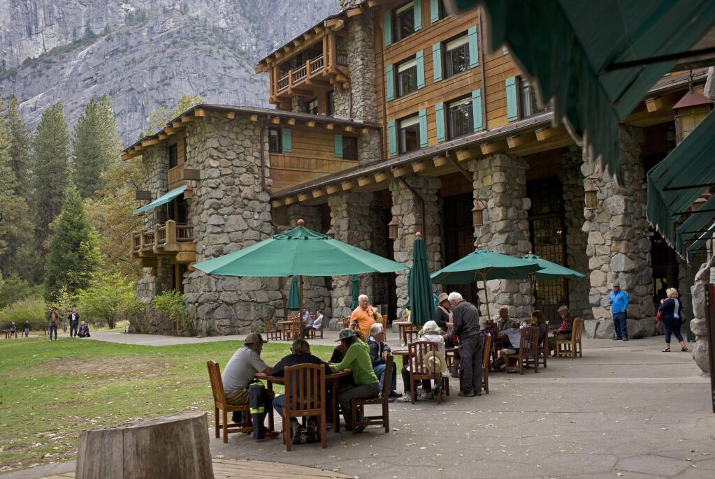 FILE - In this Oct. 24, 2015, file photo, people dine outside the Ahwahnee hotel in Yosemite National Park, Calif. Yosemite National Park is investigating about 170 reports of gastrointestinal illnesses and has confirmed two cases of norovirus, officials said Thursday, Jan. 16, 2020. The National Park Service began investigating after visitors and employees started reporting illnesses this month. (AP Photo/Ben Margot, File)