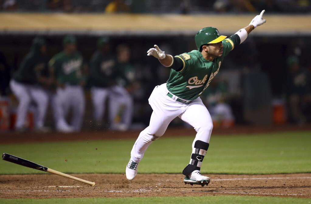 The Oakland Athletic' Ramon Laureano celebrates after making the game-winning hit against the Detroit Tigers in the 13th inning, Friday, Aug. 3, 2018, in Oakland. (AP Photo/Ben Margot)