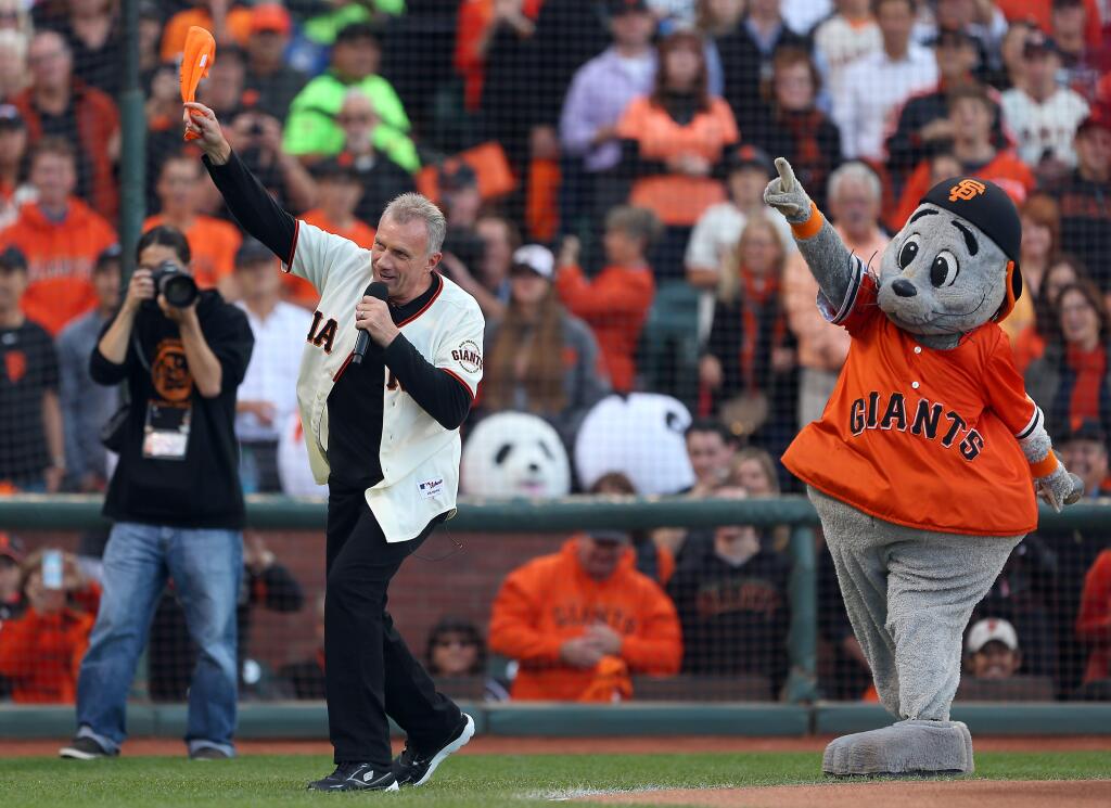 Joe Montana leads the crowd in a cheer before Game 5 of the National League Championship Series in San Francisco on Thursday, Oct. 16, 2014. The Giants defeated the Cardinals 6-3 to advance to the World Series. (Christopher Chung / The Press Democrat)