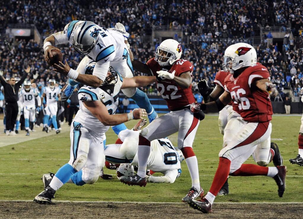 Carolina Panthers' Cam Newton leaps into the end zone for a touchdown run during the second half the NFL football NFC Championship game against the Arizona Cardinals Sunday, Jan. 24, 2016, in Charlotte, N.C. (AP Photo/Mike McCarn)