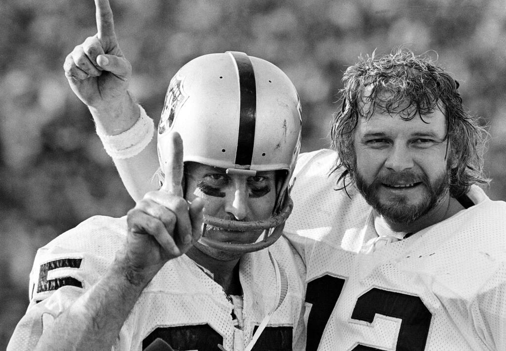 Receiver Fred Biletnikoff, left, and quarterback Ken Stabler of the Oakland Raiders proudly hold up one finger, indicating their team is No. 1, after defeating the Minnesota Vikings in the XI Super Bowl in Pasadena, Calif., on January 9, 1977. (AP Photo)