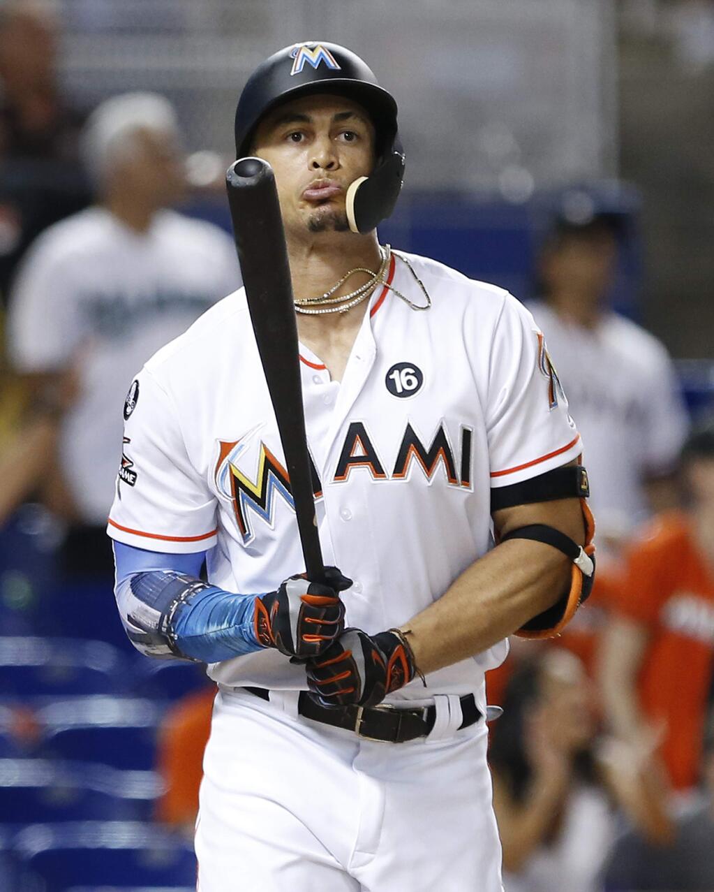In this Thursday, Aug. 31, 2017 file photo, Miami Marlins' Giancarlo Stanton reacts after he flies out during the ninth inning against the Philadelphia Phillies in Miami. (AP Photo/Wilfredo Lee, File)