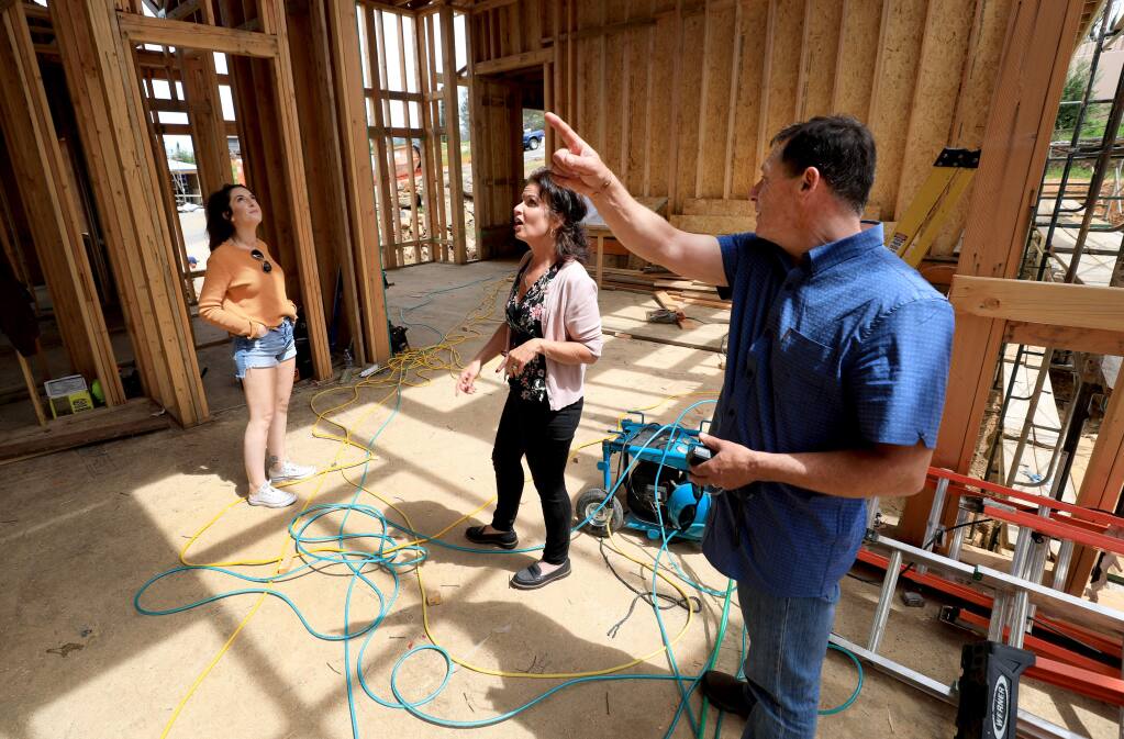 George and Regina Cuculich, tour their home being rebuilt, Friday, April 19, 2019. Daughter Claire Raggio, is at left. The home was destroyed during the Tubbs fire as it swept over Fountaingrove in October 2017 and is being constructed by the Urban Building Group. (Kent Porter / The Press Democrat) 2019