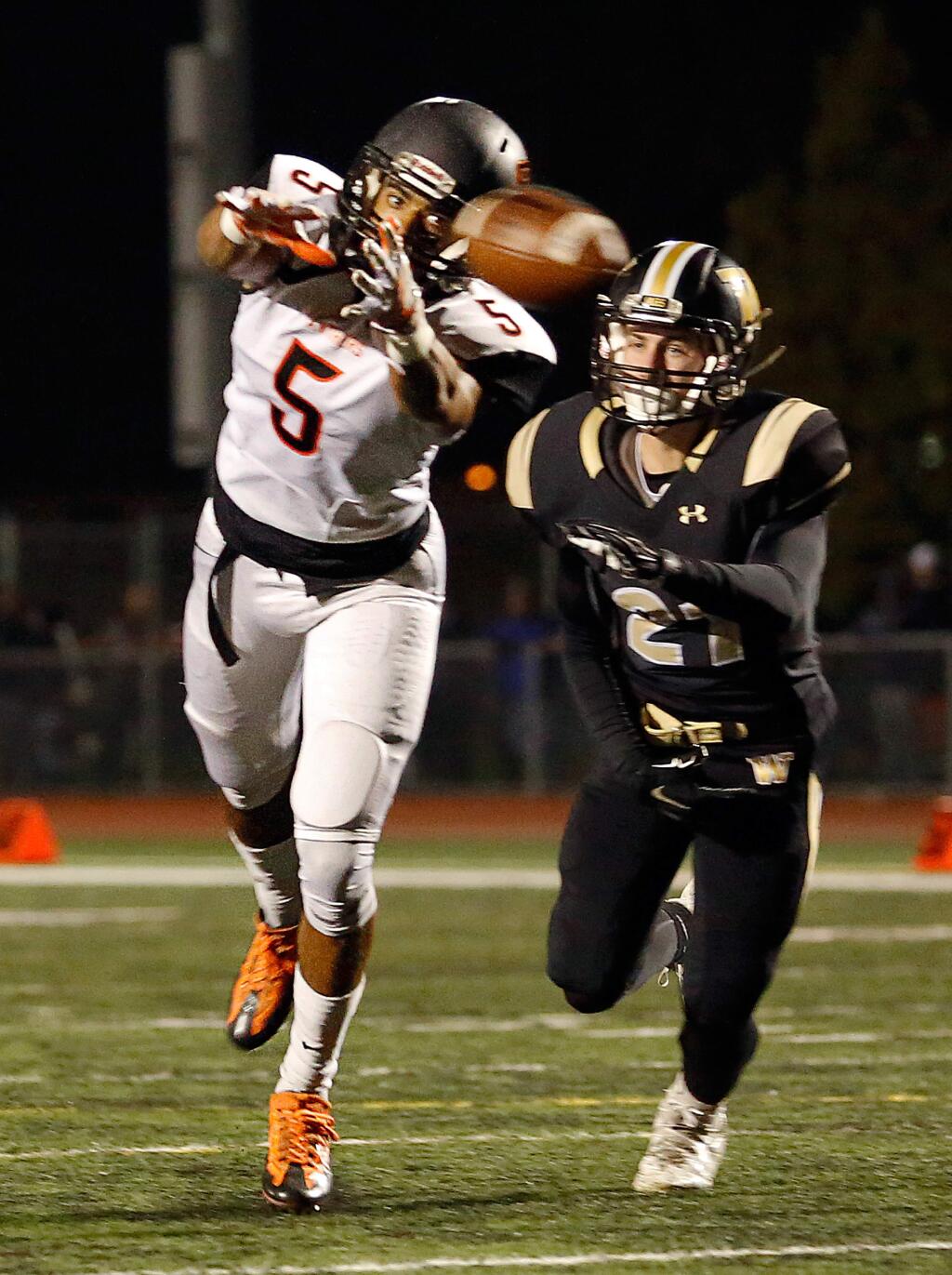 Santa Rosa's Kalei Aukai (5), left, misses catching a pass while covered by Windsor's Brett Stibi (21) during the first half of the NCS Division 2 quarterfinal football game between Santa Rosa and Windsor high schools in Windsor, California on Friday, November 18, 2016. (Alvin Jornada / The Press Democrat)