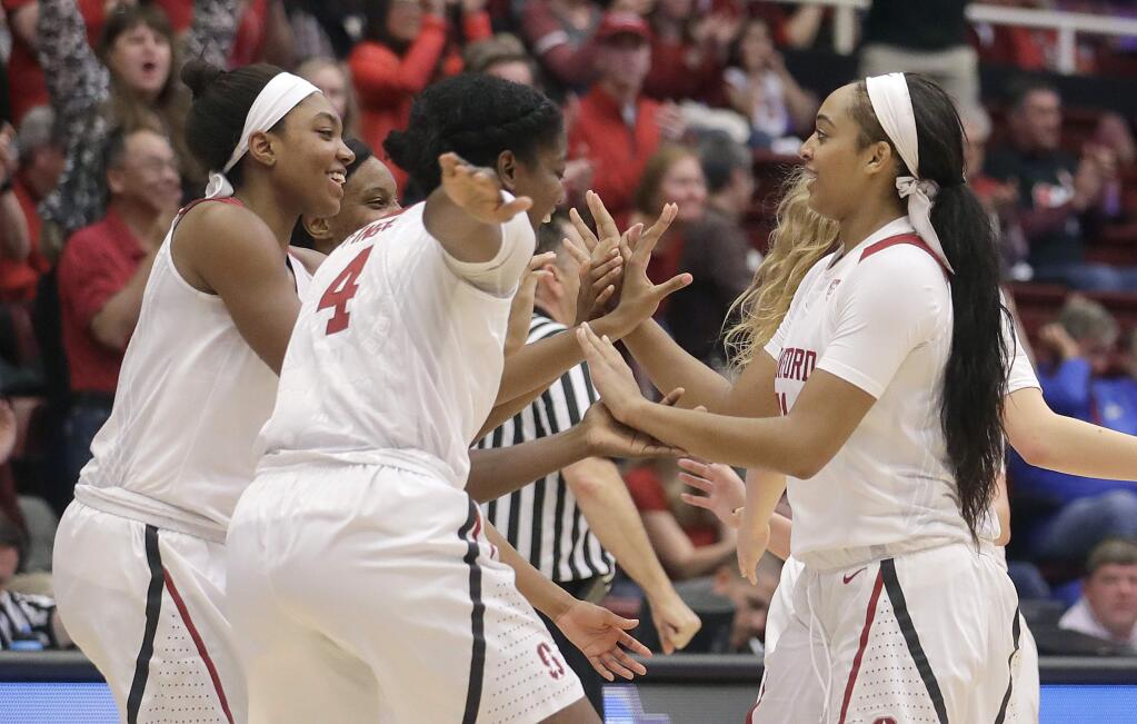 Stanford guard Dijonai Carrington, right, celebrates with teammates after scoring against Florida Gulf Coast during the second half of a second-round game in the NCAA women's tournament in Stanford, Monday, March 19, 2018. (AP Photo/Jeff Chiu)