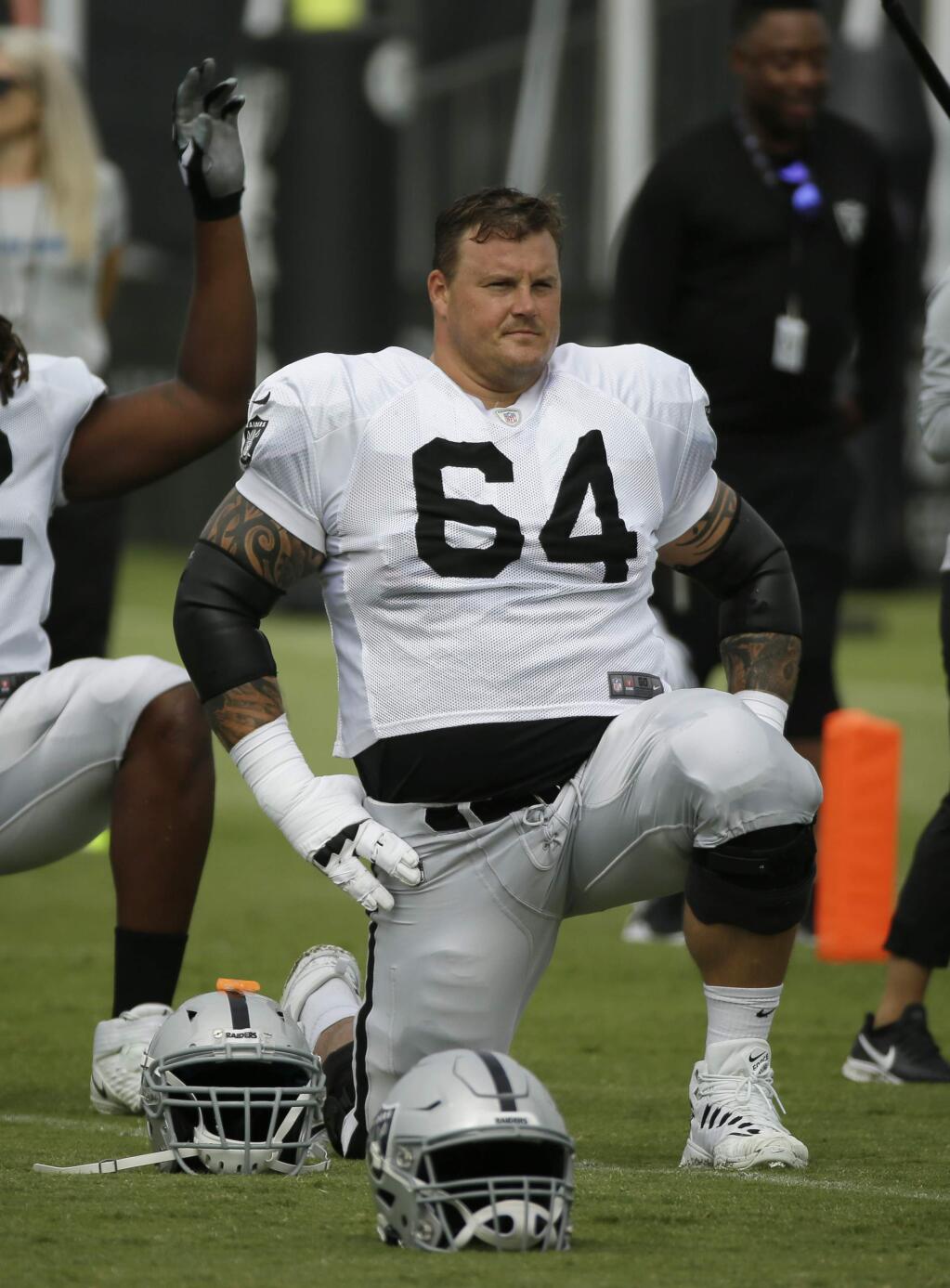 FILE - In this July 29, 2019, file photo, Oakland Raiders center Richie Incognito (64) stretches during NFL football training camp in Napa, Calif. The Oakland Raiders and their big personalities like Antonio Brown and Richie Incognito are ready to be stars on HBO's 'Hard Knocks.' (AP Photo/Eric Risberg, File)