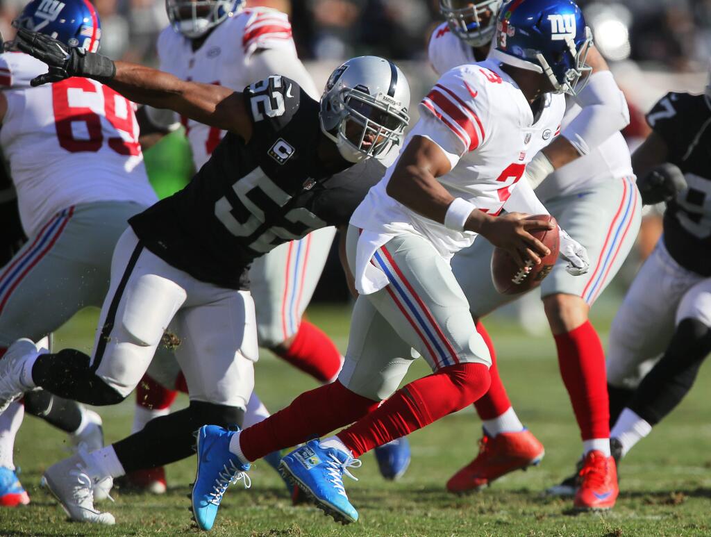 Oakland Raiders defensive end Khalil Mack pressures New York Giants quarterback Geno Smith during their game in Oakland on Sunday, Dec. 3, 2017. The Oakland Raiders defeated the New York Giants 24-17. (Christopher Chung / The Press Democrat)