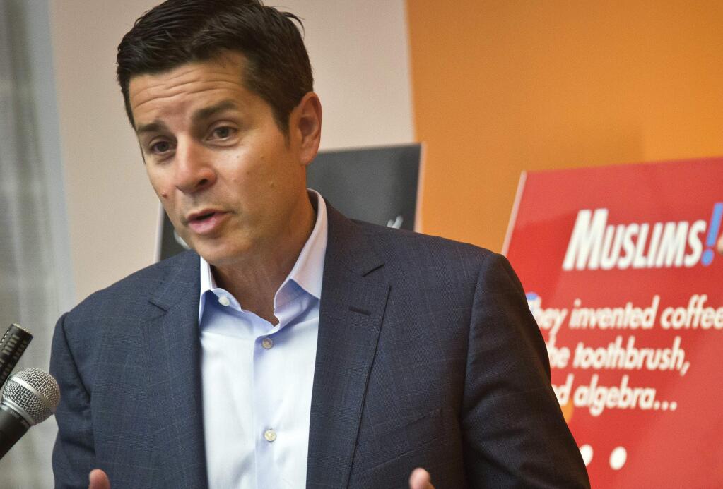 FILE - In this June 25, 2015, file photo, Muslim comedian Dean Obeidallah speaks at a news conference in New York. Obeidallah, a Muslim-American radio host, is accusing Andrew Anglin, the publisher of a notorious neo-Nazi website, of defaming him by falsely labeling him the “mastermind” of a deadly concert bombing in England, according to a federal lawsuit filed Wednesday, Aug. 16, 2017. (AP Photo/Bebeto Matthews, File)