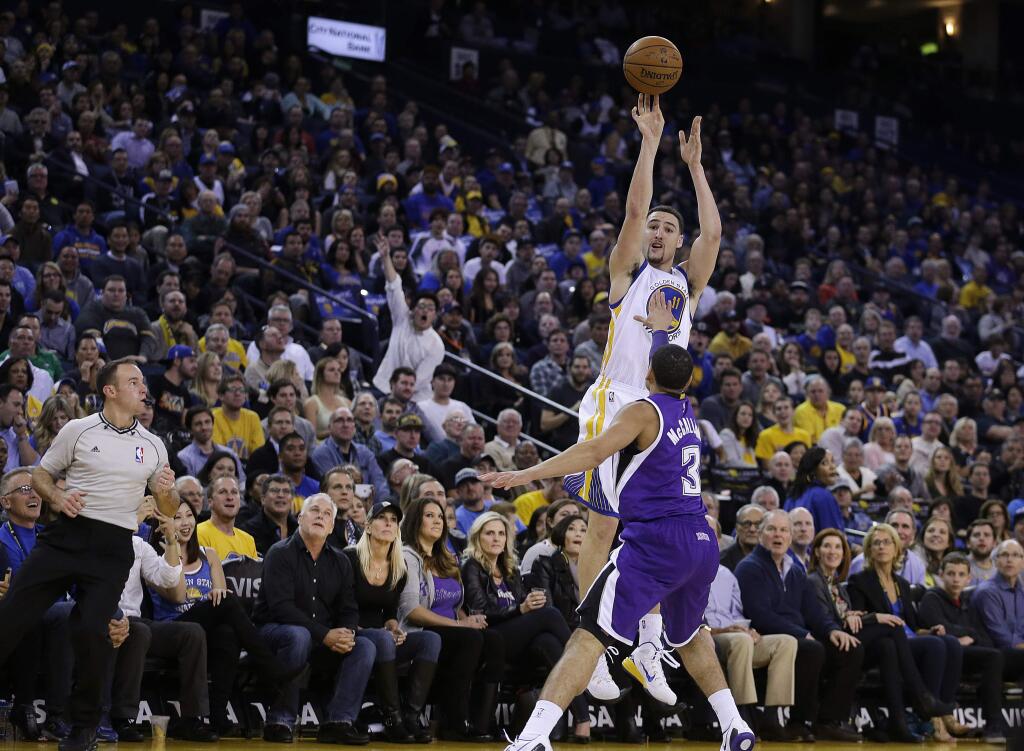 Golden State Warriors' Klay Thompson shoots over Sacramento Kings' Ray McCallum (3) during the third quarter of a game Friday, Jan. 23, 2015, in Oakland. (AP Photo/Ben Margot)
