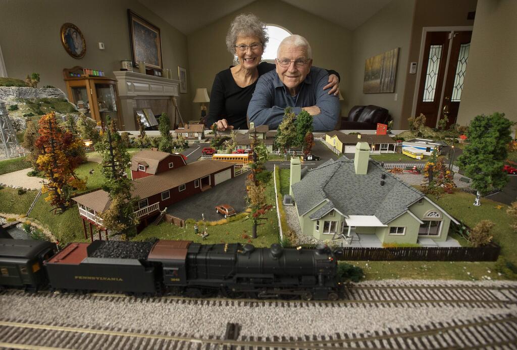 Retired Oakland firefighter David Lewis spent two years creating a train town with his wife Suzan and a little help from their grandchildren. Lewis created scale models of the three houses they lived in, his old firehouse and even a cemetery. (photo by John Burgess/The Press Democrat)