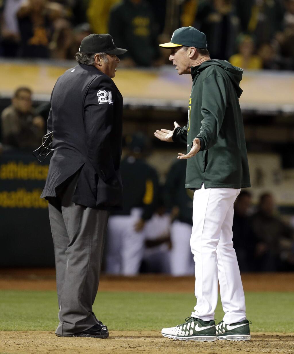 Oakland Athletics manager Bob Melvin, right, argues with home plate umpire Hunter Wendelstedt during the fifth inning of a baseball game against the Toronto Blue Jays Wednesday, July 22, 2015, in Oakland, Calif. Melvin was ejected. (AP Photo/Ben Margot)