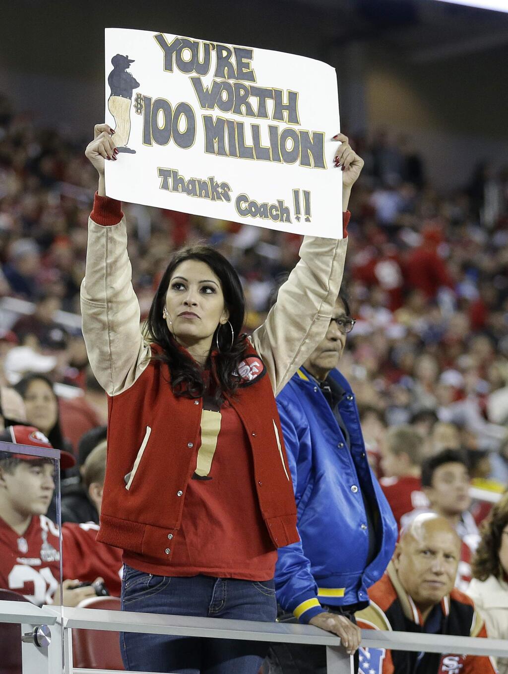 A fan holds up a sign for San Francisco 49ers head coach Jim Harbaugh during the second half of a game between the San Francisco 49ers and the San Diego Chargers in Santa Clara, Saturday, Dec. 20, 2014. (AP Photo/Ben Margot)