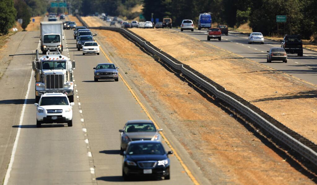 Traffic moves along a bumpy section of Highway 101, looking south from Limerick Lane north of Windsor in August. (KENT PORTER/ PD FILE, 2014)