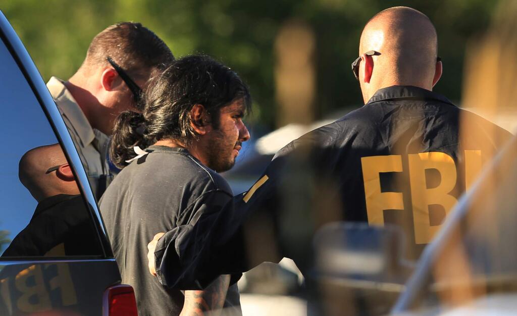 The FBI and the Sonoma County Sheriff's deputies take in to custody the second suspect in Calistoga involved in the Windsor armored car robbery, Tuesday July 12, 2016. (Kent Porter / Press Democrat) 2016