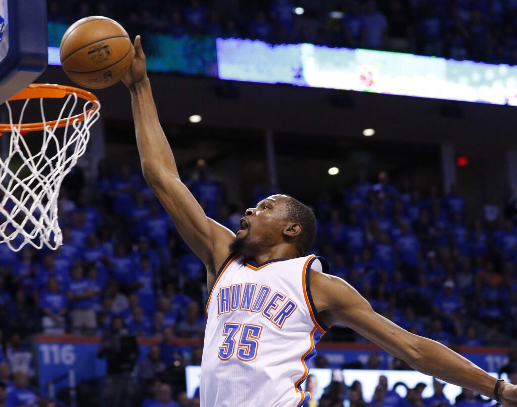 Oklahoma City Thunder forward Kevin Durant (35) dunks in the first quarter of Game 6 of a second-round NBA basketball playoff series against the San Antonio Spurs in Oklahoma City, Thursday, May 12, 2016. (AP Photo/Alonzo Adams)