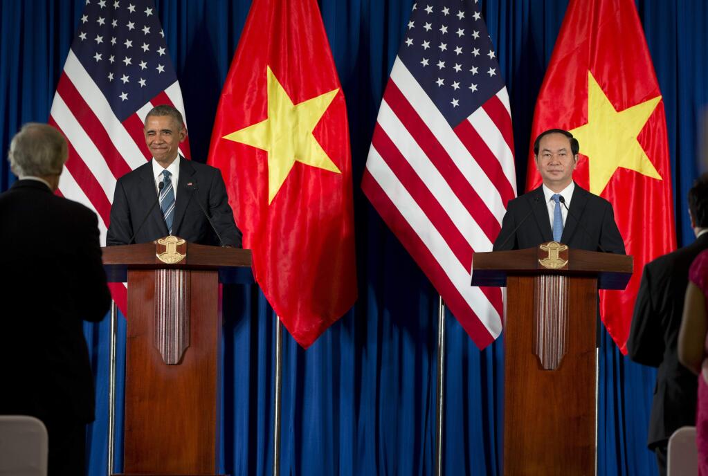 President Barack Obama, seen at a Monday news conference with Vietnamese President Tran Dai Quang, announced an expanded military relationship with Vietnam. (CAROLYN KASTER / Associated Press)