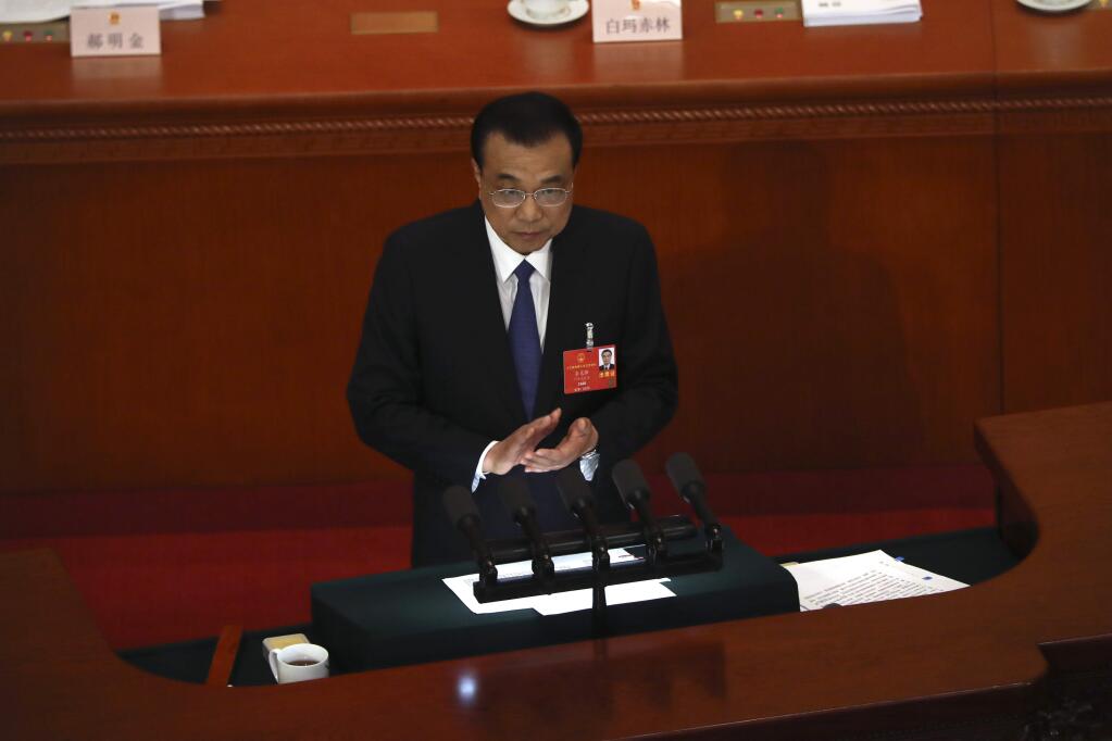 Chinese Premier Li Keqiang delivers the government work report during the opening session of China's National People's Congress (NPC) at the Great Hall of the People in Beijing, Friday, May 22, 2020. (AP Photo/Ng Han Guan, Pool)