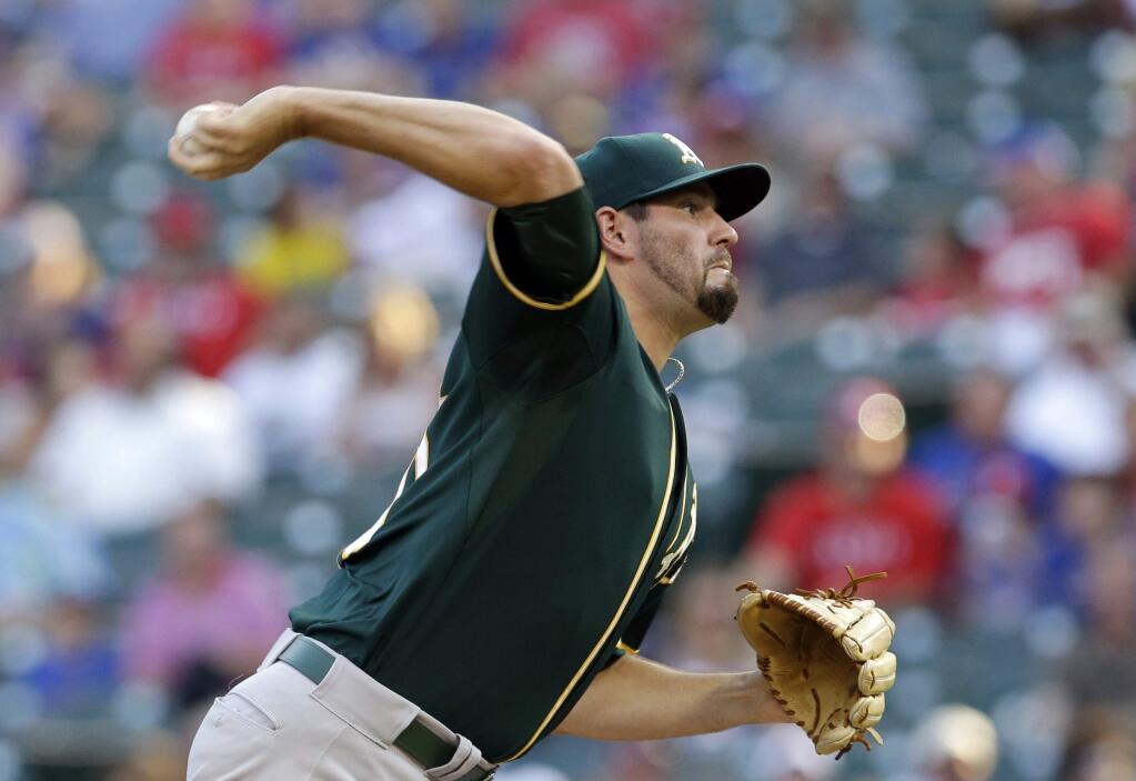 Oakland Athletics starting pitcher Jason Hammel delivers to the Texas Rangers in the first inning of a baseball game, Friday, July 25, 2014, in Arlington, Texas. (AP Photo)