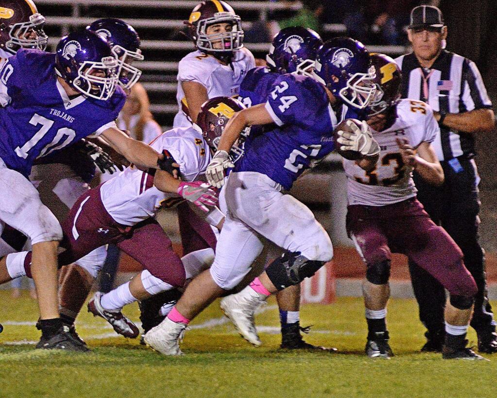 SUMNER FOWLER/FOR THE ARGUS-COURIERConnor Richardson (24) and Luke Haggard (70) were both All-Sonoma County League selections from Petaluma's Trojans.