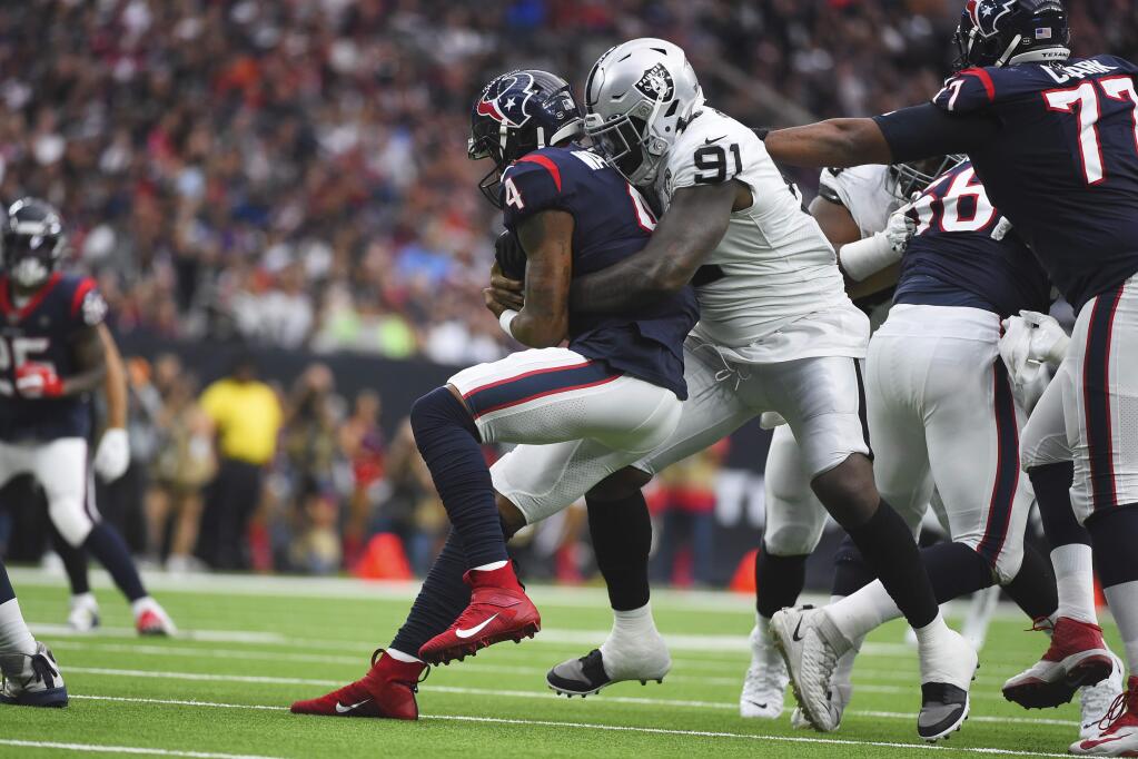 Houston Texans quarterback Deshaun Watson is hit by Oakland Raiders defensive end Benson Mayowa during the first half, Sunday, Oct. 27, 2019, in Houston. (AP Photo/Eric Christian Smith)