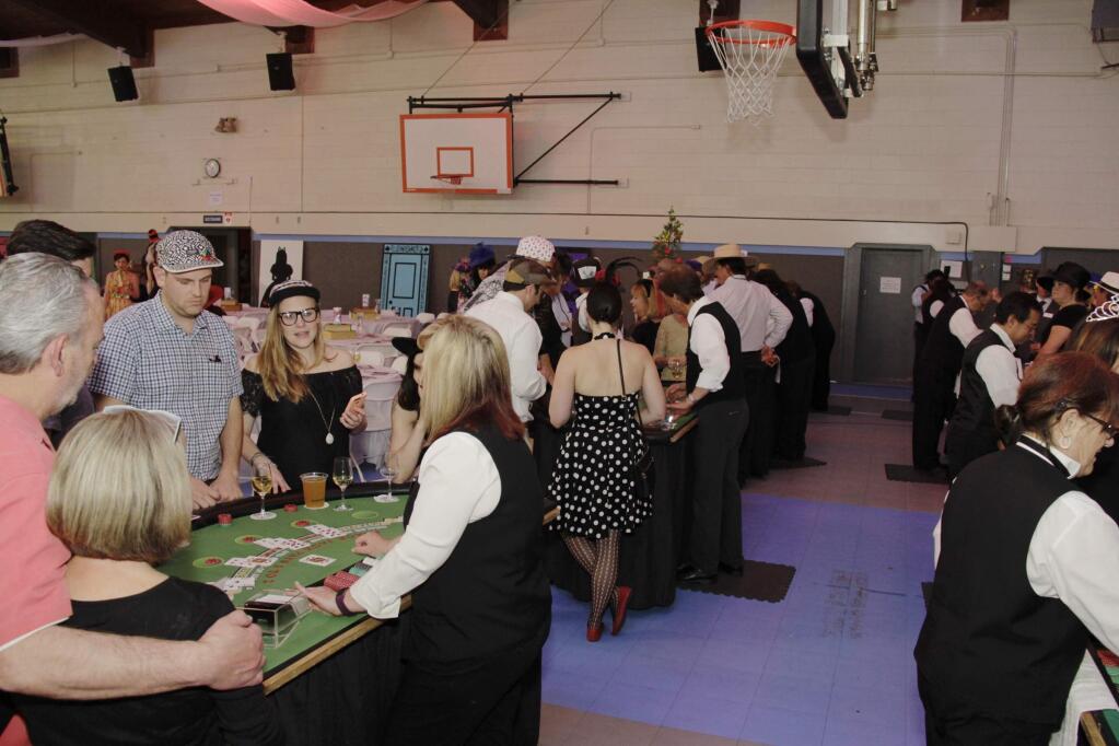 Everyone enjoying playing blackjack at the Mad Hatter Ball held on April 1, 2017 at the Mentor Me Cavanagh Center in Petaluma CA.JIM JOHNSON for the Argus Courier.