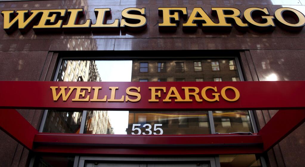 FILE - In this May 6, 2012, file photo, a Wells Fargo sign is displayed at a branch in New York. Wells Fargo said Tuesday, March 28, 2017, it will pay $110 million to settle a class-action lawsuit over up to 2 million accounts its employees opened for customers without getting their permission. (AP Photo/CX Matiash, File)