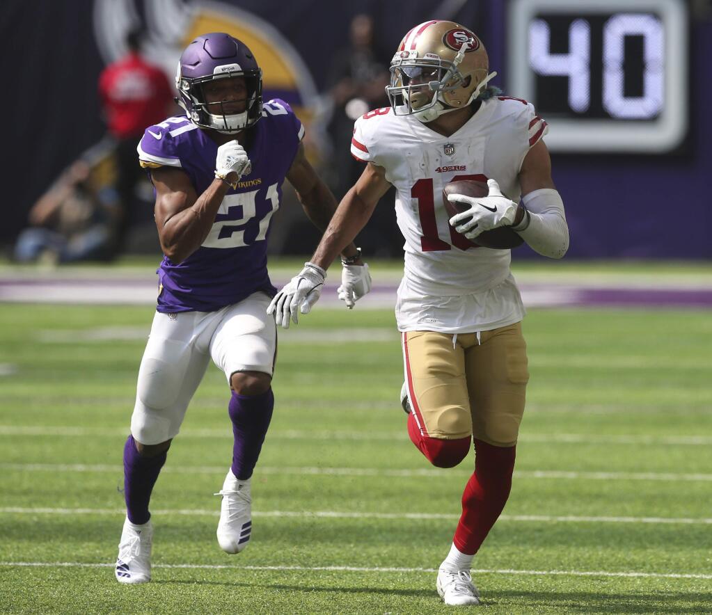 San Francisco 49ers wide receiver Dante Pettis runs from Minnesota Vikings cornerback Mike Hughes after making a reception during the second half, Sunday, Sept. 9, 2018, in Minneapolis. (AP Photo/Jim Mone)