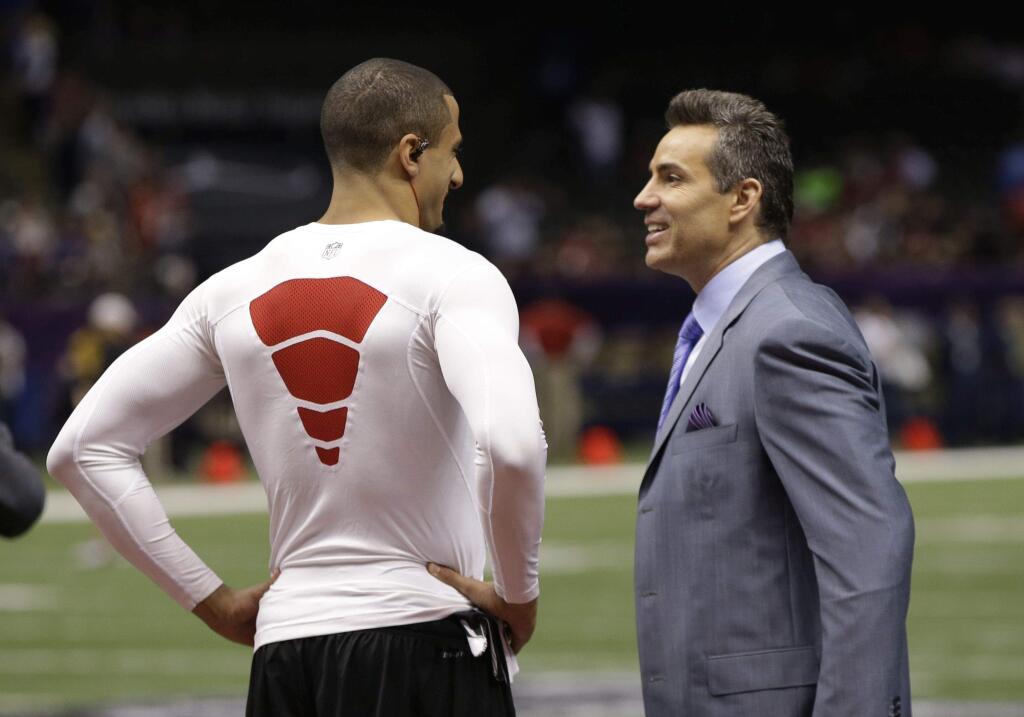 Colin Kaepernick and Kurt Warner, shown here talking at a media session for Super Bowl XLVII in New Orleans, worked today in Arizona in the offseason on improving Kaepernick's mechanics and progressions. (Mark Humphrey / Associated Press)