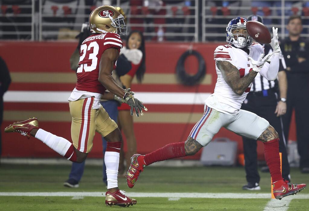 New York Giants wide receiver Odell Beckham Jr., right, catches a touchdown pass in front of San Francisco 49ers cornerback Ahkello Witherspoon (23) during the second half in Santa Clara, Monday, Nov. 12, 2018. (AP Photo/Ben Margot)