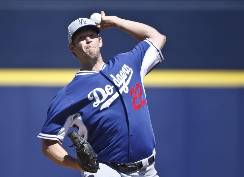 Los Angeles Dodgers starting pitcher Clayton Kershaw works against the Seattle Mariners in the first inning of a spring training game, Sunday, March 15, 2015, in Peoria, Ariz. (AP Photo/Lenny Ignelzi)