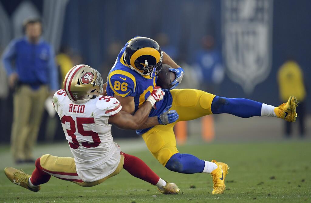 Los Angeles Rams tight end Derek Carrier, right, is tackled by San Francisco 49ers strong safety Eric Reid during the second half Sunday, Dec. 31, 2017, in Los Angeles. (AP Photo/Mark J. Terrill)