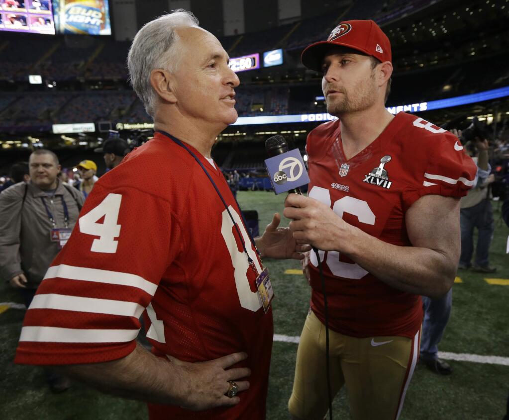 San Francisco 49ers long snapper Brian Jennings, right, interviews former 49ers player Mike Shumann during media day for Super Bowl XLVII on Tuesday, Jan. 29, 2013, in New Orleans. (AP Photo/Mark Humphrey)