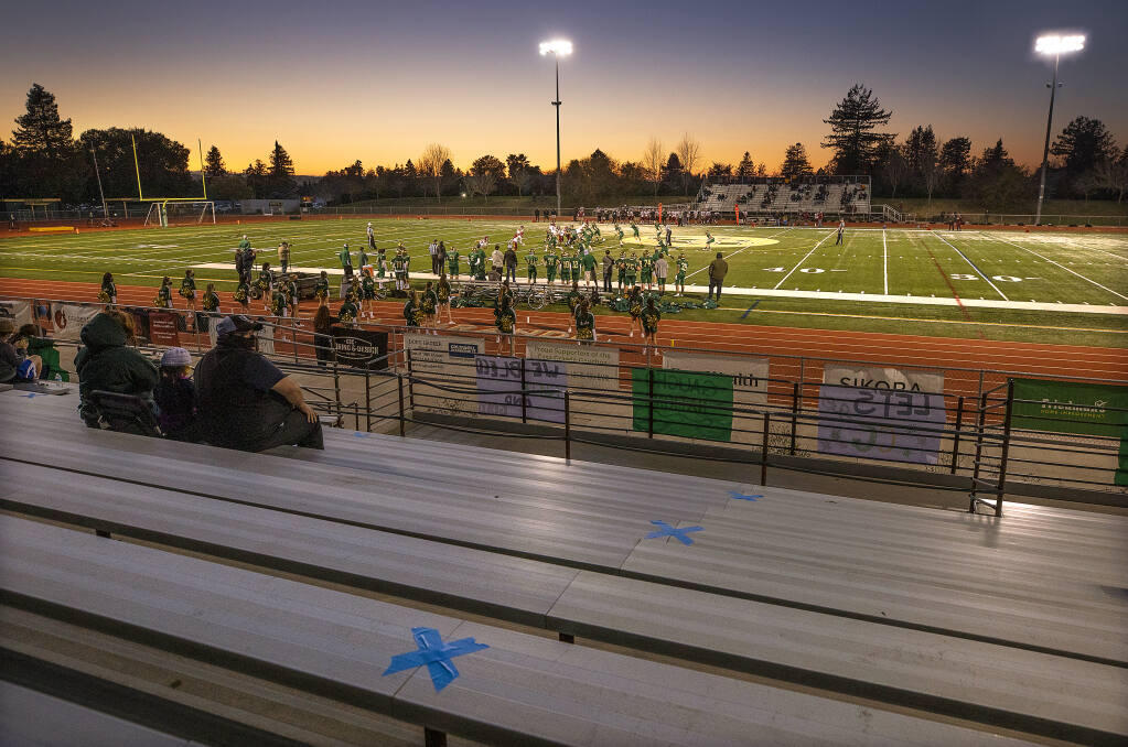 The Casa Grande football spectators were limited to family members who were walked into the stadium by their sons before the start of the game in Petaluma on Friday, March 12, 2021.  (JOHN BURGESS/THE PRESS DEMOCRAT)