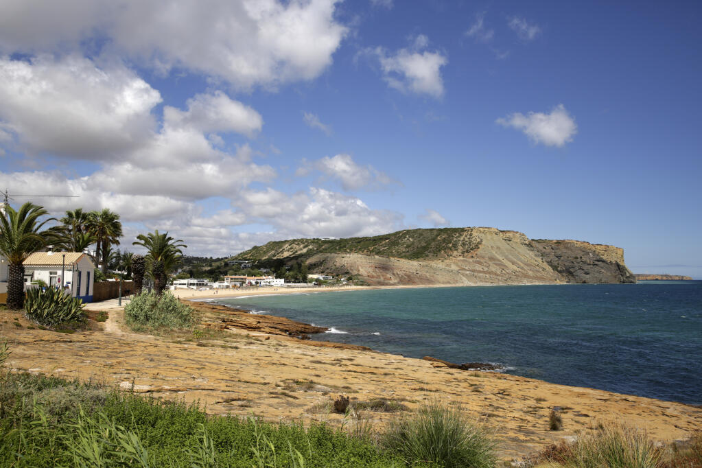 FILE - A view of the coastline in Praia da Luz, in Portugal's Algarve coast, on June 4, 2020. Portuguese police say they'll resume searching for Madeleine McCann, the British toddler who disappeared in the country’s Algarve region in 2007, in the next few days. Portugal's Judicial Police released a statement confirming local media reports that they would conduct the search at the request of the German authorities and in the presence of British officials. (AP Photo/Armando Franca)