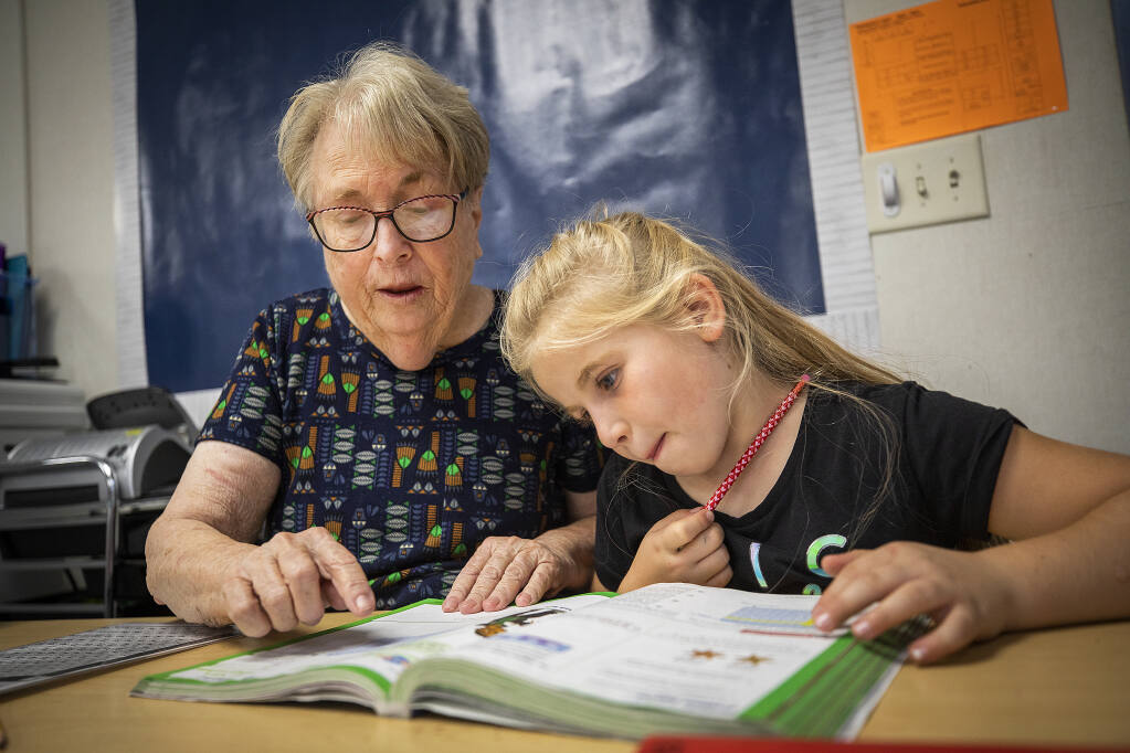 “Grandma Maureen” Conway helps Lakeport elementary school third grader Abbie Sabol, 8 with her math October 28, 2022. Conway earns a stipend for her work through the Foster Grandparents Program in Lake County. (John Burgess/The Press Democrat)
