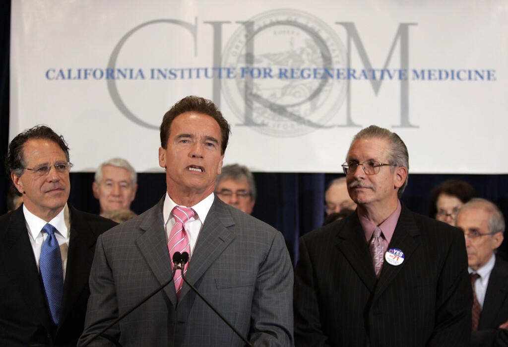 FILE - In this Feb. 16, 2007, file photo, then-California Gov. Arnold Schwarzenegger is surrounded by supporters of the California Institute for Regenerative Medicine, during a news conference in Burlingame, Calif., to announce the recipients of grants from CIRM. California voters have narrowly approved a ballot question that will keep alive the state's first-of-its-kind stem cell research program. Proposition 14 was backed by 51% of voters. It calls for a bond sale to generate a $5.5 billion infusion for CIRM, which was created by a similar 2004 bond measure but now is nearly broke. (AP Photo/Paul Sakuma, File)