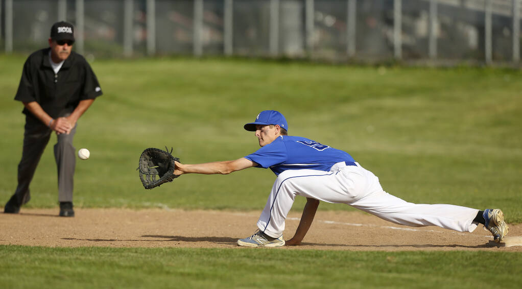 Analy's Garrett Hill stretches to make the out on first during his game against Petaluma in the A.L. Rabinovitz Tournament at Montgomery High School in Santa Rosa on Thursday, March 20, 2014. (Conner Jay / The Press Democrat)