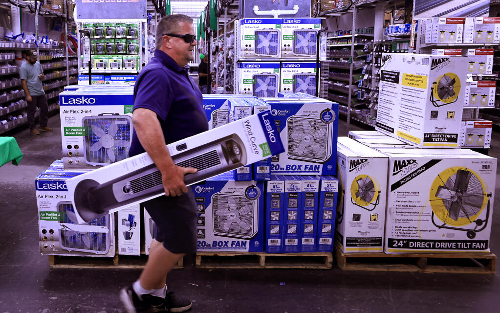 Greg Fleming from Windsor picks up a new cooling fan, Thursday, July 13, 2023 at Friedman's Home Improvement in Santa Rosa, after Fleming's daughter appropriated his, in preparation for the upcoming heat wave Friday through the weekend. (Kent Porter / The Press Democrat)