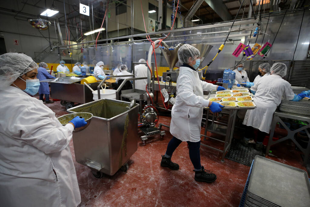 Employees prepare Indian Vegetable Korma frozen meals in the Amy's Kitchen production facility in Santa Rosa, Calif., on Wednesday, February 16, 2022. (Beth Schlanker/The Press Democrat)