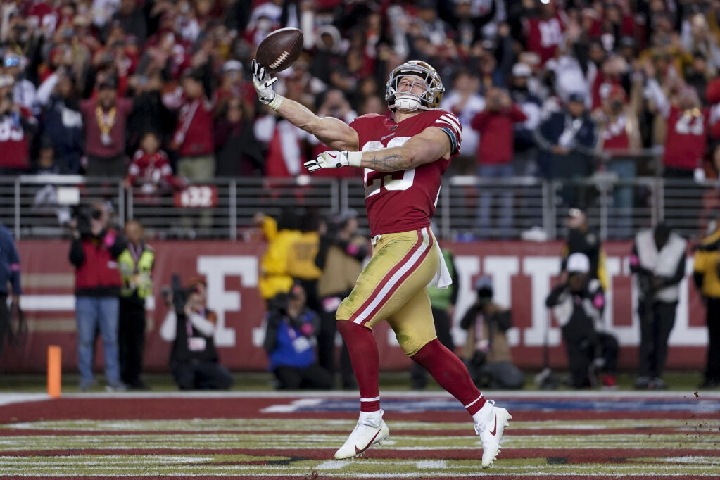 49ers running back Christian McCaffrey celebrates after scoring against the Dallas Cowboys during the second half of Sunday’s divisional round playoff game in Santa Clara. (Godofredo A. Vásquez / ASSOCIATED PRESS)