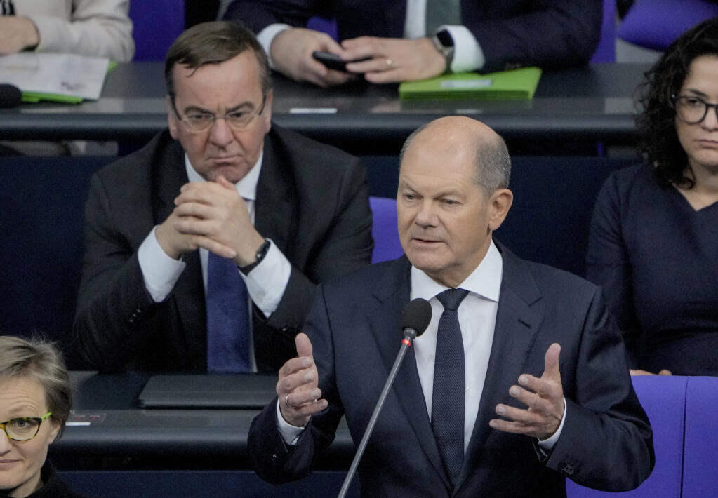 German Chancellor Olaf Scholz, right, speaks to the lawmakers in the German parliament Bundestag in Berlin, Wednesday, Jan. 25, 2023. Left is defense minister Boris Pistorius. The German government has confirmed it will provide Ukraine with Leopard 2 battle tanks and approve requests by other countries to do the same. (Photo/Markus Schreiber)