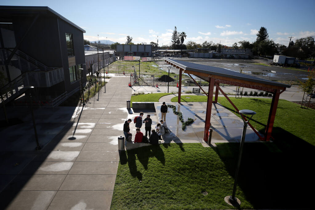 Students gather at stage in the courtyard of the new classroom building at Cardinal Newman High School in Santa Rosa, Calif., on Tuesday, December 14, 2021.(Beth Schlanker/The Press Democrat)